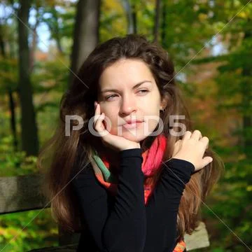 Young woman in autumn park Stock Photos