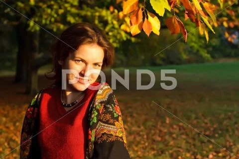 Young woman in autumn park Stock Photos