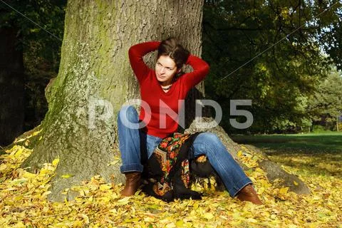 Young woman in autumn park Stock Photos