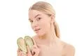 The young woman with an avocado on the white background Photo