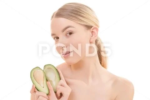 The young woman with an avocado on the white background Stock Photos