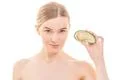 The young woman with an avocado on the white background Photo