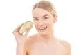 The young woman with an avocado on the white background Photo