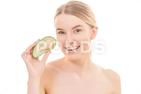The young woman with an avocado on the white background Stock Photos