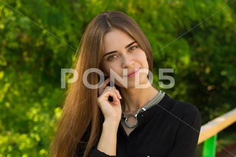 Young woman on the background of trees Stock Photos