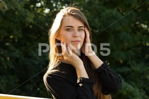 Young woman on the background of trees Stock Photos