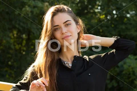 Young woman on the background of trees Stock Photos