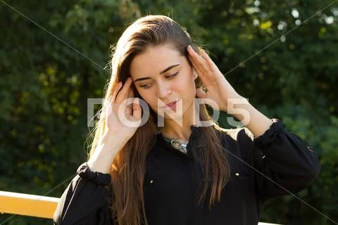 Young woman on the background of trees Stock Photos