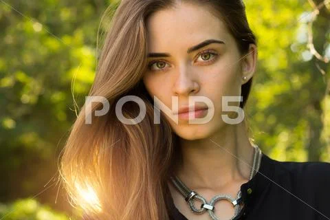 Young woman on the background of trees Stock Photos