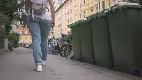 Young woman with backpack walking down the street alone Stock Footage 132060799