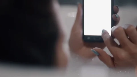 Young Woman In Bath Using Smartphone Stock Footage 84587259