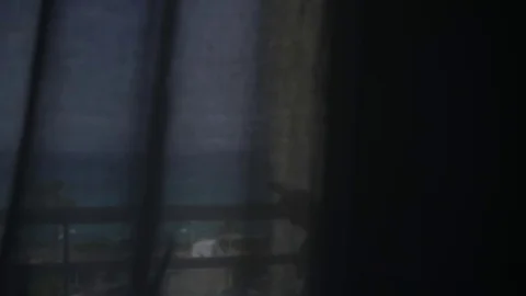 Young woman in bathrobe messages using touchsreen phone at the balcony. Handheld Stockbeeldmateriaal 76989853