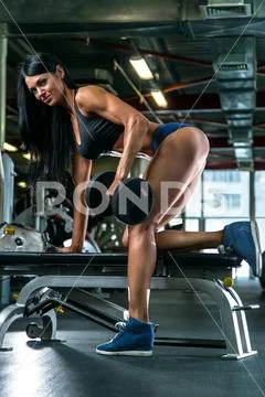 Athletic Young Woman Showing Muscles of the Back Stock Photo
