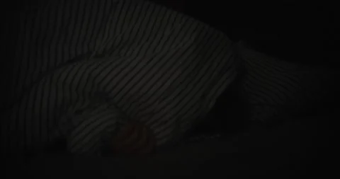 Young woman in bed opened her eyes insomniac shining bright blue light Stock Footage 218317504