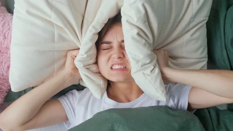A Young Woman in Bed Tries To Rest, Irritated By Noisy Neighbors. Insomnia Stock Footage