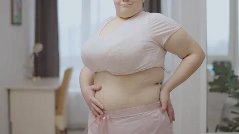 Young woman with belly fat sucking in st, Stock Video