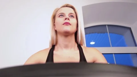 Young woman biking in the gym Stock Footage 72828853