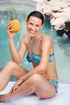Young woman in bikini holding ananas Stock Photos