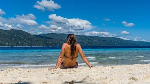 Young woman in bikini relaxing by the beach Stock Photos