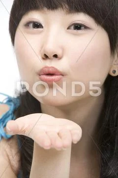 Young woman blowing a kiss Stock Photos