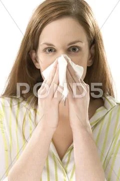 Young Woman Blowing Nose, Close-Up