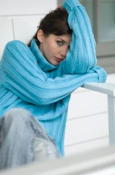 Young woman with blue pullover looking at the camera, outdoors Stock Photos