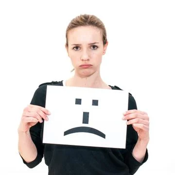 Young woman with board sad emoticon face sign Stock Photos