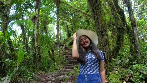 A young woman with bracelets standing in a forest while smiling Stock Footage 151281353
