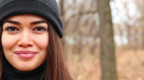 Young woman with brackets on teeth looking at copy space, smiling outdoor 스톡 동영상 56980153