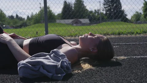 Young Woman Breathing Heavily While Layi... | Stock Video | Pond5