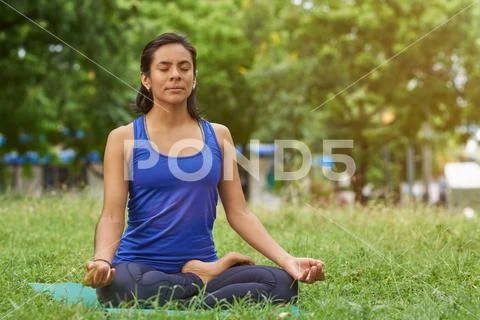 Young woman breathing in yoga pose Stock Photos