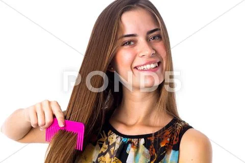 Young woman brushing her long hair Stock Photos