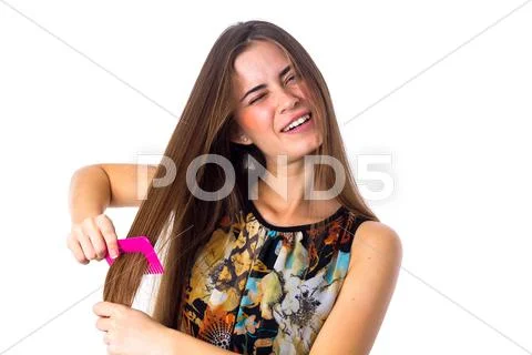 Young woman brushing her long hair Stock Photos