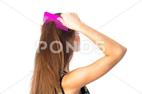 Young woman brushing her long hair Stock Photos