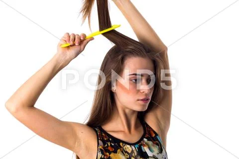 Young woman brushing her long hair Stock Photos