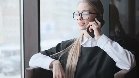 Young woman in a business suit talking on a cell phone. portrait of a business Stock Footage