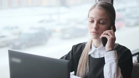 Young woman in a business suit talking on a cell phone. Portrait of a business Stock Footage