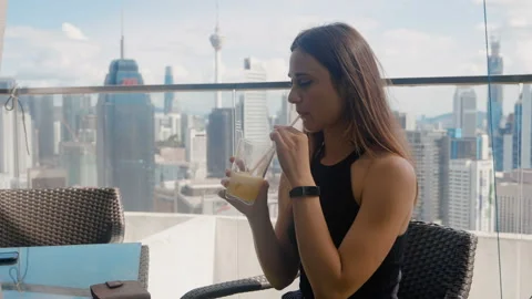 Young woman in a cafe while drinking juice discovers a lack of cash. She is Stock Footage 124845038