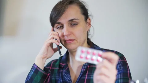 Young Woman Calling Doctor about Pills Stock Footage