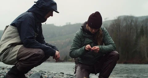 A young woman changes the lure on her Fly Fish Rod Stock Footage 102188045