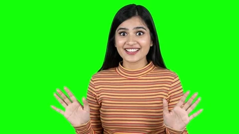 Young Woman Changing Expression from Shocked to Excited on Green Screen Stock Footage 337940708
