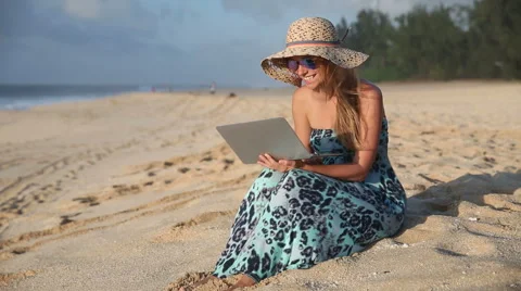 Young Woman Chatting On Computer At The Beach Stock Footage 55851472