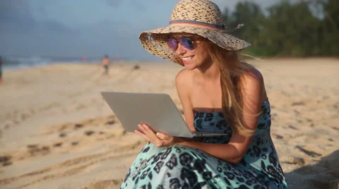 Young Woman Chatting On Computer At The Beach Stock Footage 55851719