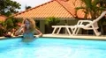 Young Woman Chatting on Smart Phone in Swimming Pool. HD Footage