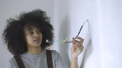 Young Woman Checking Electrical Wires in New House Stock Footage 313350261
