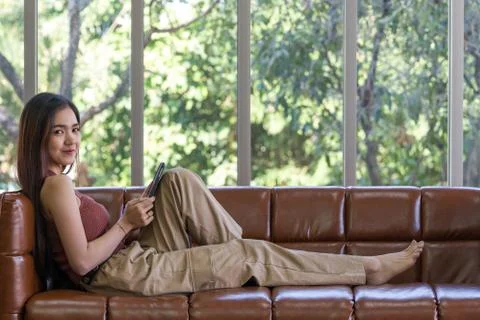 The young woman is checking email using a tablet computer. Stock Photos