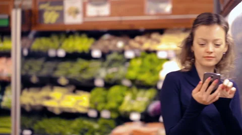 Young woman checking her grocery list on smart phone. Stock Footage