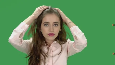 Young woman checking her makeup considering camera as a mirror Stock Footage
