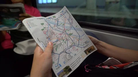 Young woman checking map while riding train subway Stock Footage 122173254