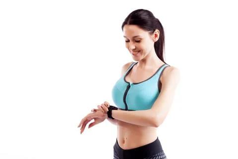 Young woman checking progress on smart watch on a  white isolated background  Stock Photos